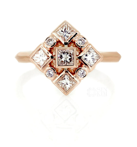 custom made geometric ring with princess cut and round diamonds set in rose gold bezel ring.