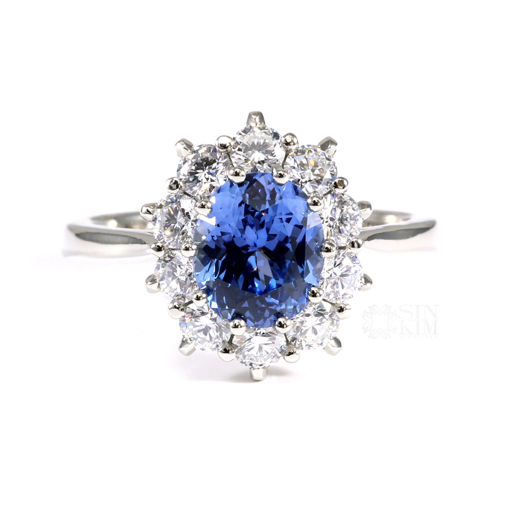Ethically sourced, unheated, untreated, oval blue sapphire set with 10 excellent cut round brilliant cut diamonds in a Princess Diana inspired Sapphire Engagement ring.