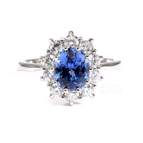 Ethically sourced, unheated, untreated, oval blue sapphire set with 10 excellent cut round brilliant cut diamonds in a Princess Diana inspired Sapphire Engagement ring.