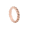 A rose gold eternity ring featuring a continuous row of small round-cut dark green gemstones set in a textured, leaf-like band, photographed on a clean white background.