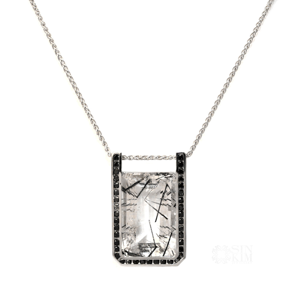Fascinating tourmaline inclusions happen naturally in quarts crystals, creating a look of branches frozen in ice.  The Winter Lake Necklace is inspired by this icy image.  The large octagonal gem is set in 14k white gold with black diamonds channel set around it. One of a Kind.  Ethically sourced.  Made in Canada