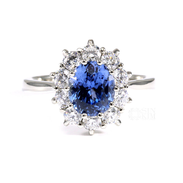 Ethically sourced, unheated, untreated, oval blue sapphire set with 10 excellent cut round brilliant cut diamonds in a Princess Diana inspired Sapphire Engagement ring. 
